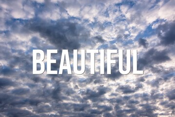 BEAUTIFUL - word on the background of the sky with clouds.