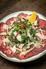 beef Carpaccio with salad and parmesan cheese