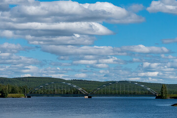 Obraz premium Umea, sweden A steel arch bridge over the Umea river, or Umeaalven.