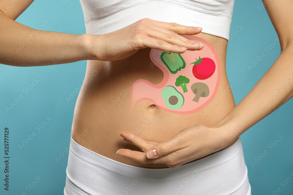 Sticker Woman with image of stomach full of food drawn on her belly against light blue background, closeup. Healthy eating habits