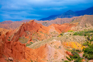 Fototapeta na wymiar Natural unusual landscape red canyon of extraordinary beauty is similar to the Martian landscape. Multi-colored canyon fairy tale in Kyrgyzstan. Charyn Canyon. Amazing beautiful landscape.