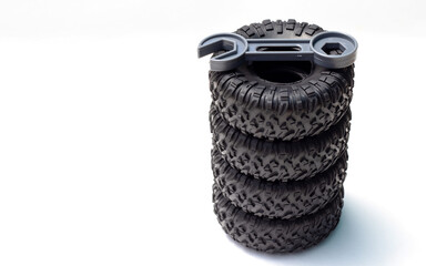 tire replacement change concept.rubber black tires from toy car and plastic wrench key...