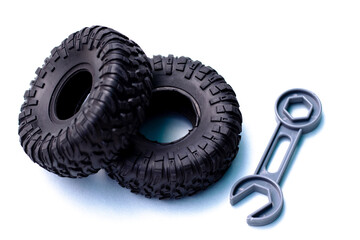 tire replacement change concept.rubber black tires from toy car and plastic wrench key...