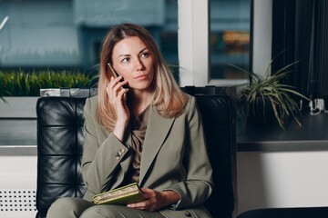 Business woman young adult coach using mobile phone at office chair
