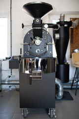 Coffee roaster machine at coffee roasting process.
