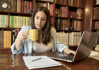 Modern writer writing a novel on a laptop