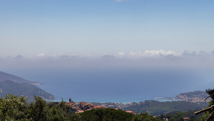 Fototapeta premium Little Medieval village Sant'Ilario on the quiet hill in the middle of the Monte Perone, with a breathtaking view of the gulf of Marina di Campo. Island of Elba, Italy