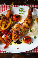 Rustic fried chicken legs with assorted vegetables and rice