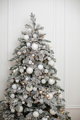 White Christmas tree in white interior home holidays