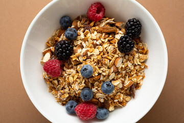 Overhead view of breakfast bowl with granola and berries food
