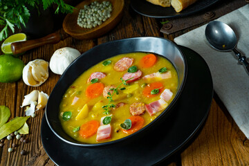Hearty rustic pea soup with bacon and sausage