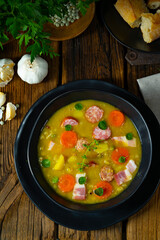 Hearty rustic pea soup with bacon and sausage