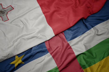 waving colorful flag of central african republic and national flag of malta.