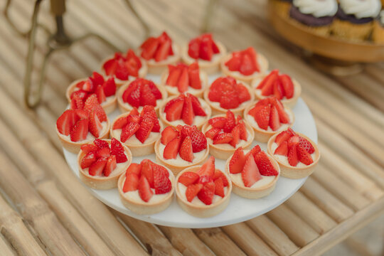 mini cakes with fresh strawberries on a wedding buffet