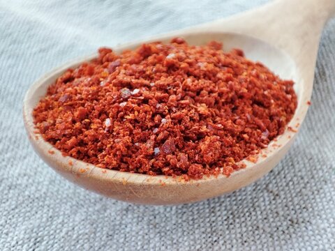 hot red Korean pepper on a wooden plate. Asian spicy spices.