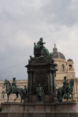 Fototapeta na wymiar a young European-looking girl poses on Maria Theresa Square in Vienna