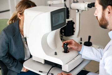 Close-up view of a optometrist checks patient's vision in an optics store or ophthalmology clinic
