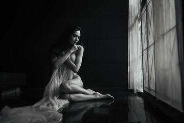 black and white young asian women model sitting poses naked by the window light only a thin curtain...