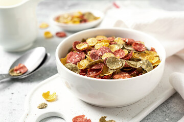 Vegetable flakes for a healthy breakfast in a white plate on a bright kitchen table close-up