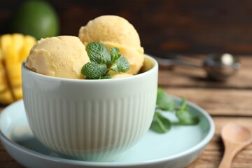 Delicious mango ice cream served on table, closeup