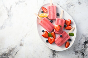 Traditional homemade berry popsicles on a plate