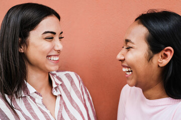 Hispanic friends having fun laughing together outdoor - Focus on right girl eye