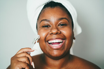 African young woman doing skin care treatment - Focus on eyes