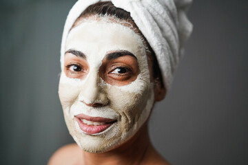 Senior woman doing beauty treatment using beauty skin mask - Main focus on nose
