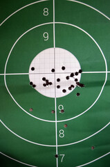 A round target  for shooting practice on the shooting range   with bullet holes