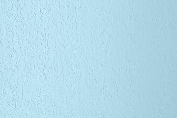 Naklejka premium Pastel light blue colored low contrast Concrete textured background. Empty colourful wall texture with copy space for text overlay and mockups. 2023, 2024 color trend