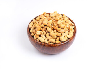 Roasted Cashew nuts in a wooden bowl, white background