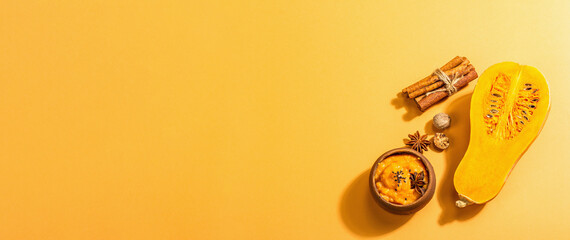 Half of the raw pumpkin with butternut squash puree and spices. Assortment ingredients for cooking