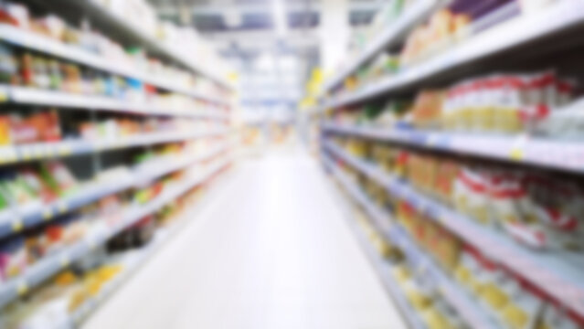 Abstract blur image of supermarket background. Defocused shelves with CPG product. Grocery shopping. Store. Retail industry. Rack. Food crisis concept. Increased demand. Consumer price inflation