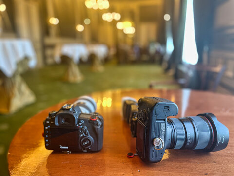  camera gear of professional photographer on table and includes lenses, bodies and a flash light -the hague, netherlands - may 15 2022