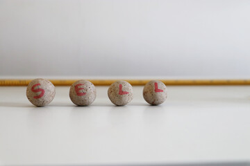 share market Sell handwritten on balls in white