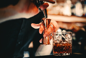 man bartender hand making cocktail in bar