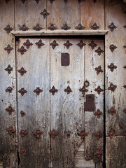 Puerta antigua de madera con clavos de hierro.