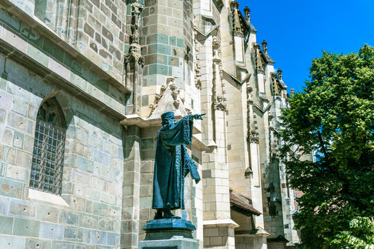 Brasov,Romania - August 20 2022: Black Church from Brasov and the statue of Honterus, large gothic building architecture