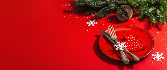 Served Christmas table setting in red tones with vintage cutlery