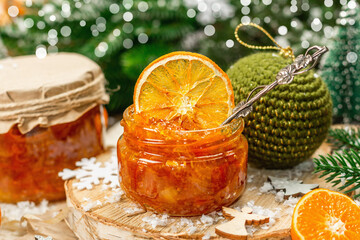 Orange marmalade or orange jam in glass jars. Sweet confiture with festive Christmas decor