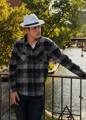 Stylish looking young man wearing a white hat.