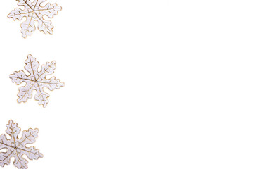 Christmas minimal left side border made of decorative snowflakes isolated on white. Copy space.