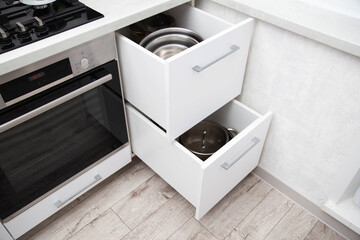 Modern drawers in the kitchen for storing utensils. Kitchen making, close-up