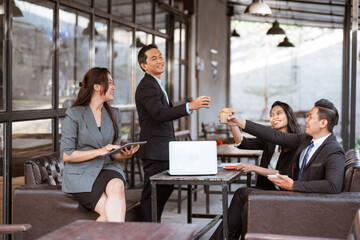 relaxed business worker enjoy drinking after finishing the meeting with partner in coffe shop