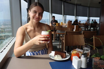 a girl eats a classic Austrian dessert sacher cake with whipped sour cream and mirabella sweet berry syrup