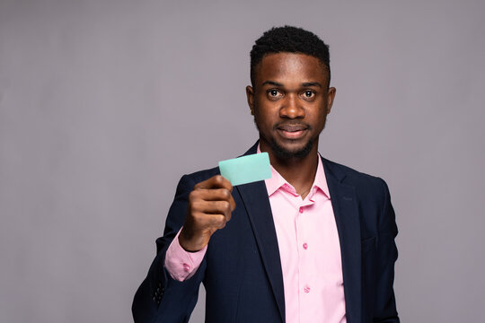 black man holding a card