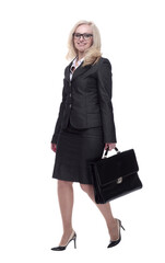 smiling business woman with a leather briefcase striding forward