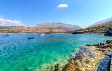 Obraz premium The beautiful Greek coastline with crystal clear waters and many boats anchored near Diros caves in Greece. A stunning scenery, perfect for swimming.