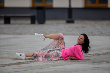 Young girl posing on stone pavement, fashion and sport