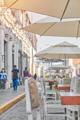 Outdoor cafe on cobblestone street, Picturesque street with traditional houses and cafe tables in the city of Arequipa in Peru.